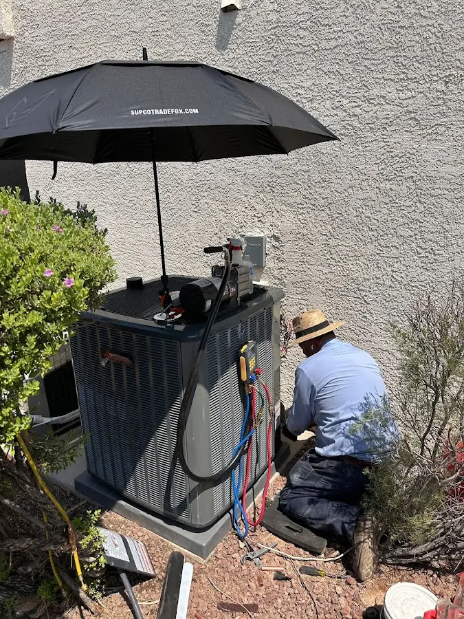 HVAC technician performing outdoor AC maintenance in Pismo Beach